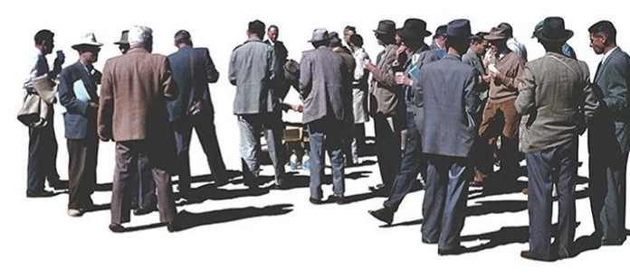 A group of people standing together in conversation